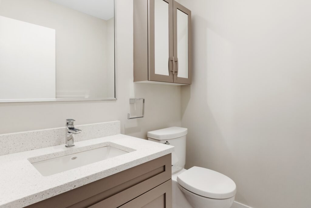 Small bathroom with quartz vanity, undermount sink and white toilet